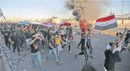  ??  ?? Iraqi protesters take part in a demonstrat­ion in the Baghdad’s central Khellani Square on Friday.