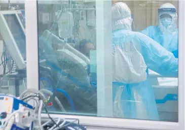  ??  ?? IN DEMAND: Medical personnel attend to a Covid-19 patient at the intensive medical unit at Thammasat University Hospital, which has also opened a field hospital at the university’s Rangsit campus.