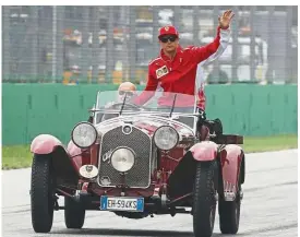  ?? — AP ?? New chapter in life: Kimi Raikkonen waving from a classic Alfa Romeo during the drivers’ parade ahead of the Italian Grand Prix at the Monza on Sept 2. Raikkonen is leaving Ferrari for Sauber.