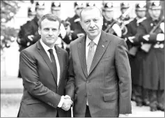  ??  ?? Macron (left) welcomes his Turkish counterpar­t Erdogan upon his arrival for their meeting and luncheon at the Elysee palace in Paris. — AFP photo