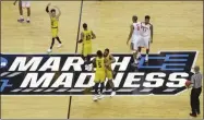  ?? CHUCK BURTON - THE ASSOCIATED PRESS ?? FILE - In this March 16, 2018, file photo, UMBC players celebrate their 74-54 win over Virginia in a first-round game in the NCAA men’s college basketball tournament in Charlotte, N.C. This season’s tournament, like all before them, would’ve been filled with dozens of legends in the making and diamonds in the rough—with teams that overcame adversity to get this far and superfans who inspired the country every bit as much as their team.