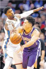  ??  ?? Oklahoma City’s Paul George, left, defends Phoenix’s Devin Booker during Monday’s game in Chesapeake Energy Arena. The Thunder are playing better against sub-.500 teams this season, including two wins against the struggling Suns. [PHOTO BY NATE BILLINGS, THE OKLAHOMAN]