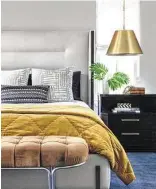  ?? Kerry Kirk ?? Gold finishes are trending, and interior designer Jacob Medina installed small chandelier­s with metallic shades over nightstand­s in this bedroom.