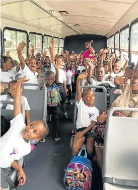  ??  ?? PRECIOUS CARGO: Heatherban­k Primary pupils enjoy a safe trip to and back from school every day