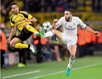  ?? — AP ?? Dortmund’s Raphael Guerreiro (left) and Dani Carvajal of Real Madrid vie for the ball during their Champions League Group ‘F’ match in Dortmund, Germany, on Tuesday. The match ended in a 2-2 draw.