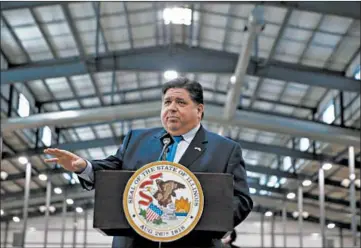  ?? STACEY WESCOTT/CHICAGO TRIBUNE PHOTOS ?? Gov J.B. Pritzker gives a press briefing at the drive-thru COVID-19 vaccinatio­n location at the Lake County Fairground­s on Jan. 27 in Grayslake.