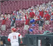  ?? AARON DOSTER — THE ASSOCIATED PRESS ?? Members of the Cincinnati Reds’ grounds crew react as Reds’ Joey Votto runs the bases after hitting a two-run home run during the first inning of Wednesday night’s game against the Milwaukee Brewers in Cincinnati.