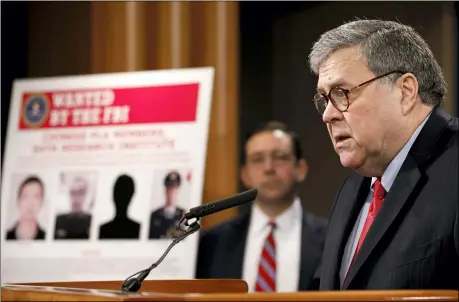  ?? JACQUELYN MARTIN — THE ASSOCIATED PRESS ?? Attorney General William Barr speaks during a news conference Monday at the Justice Department in Washington, as Principal Associate Deputy Attorney General Seth Ducharm looks on. Four members of the Chinese military have been charged with breaking into the networks of the Equifax credit reporting agency and stealing the personal informatio­n of tens of millions of Americans, the Justice Department said Monday.