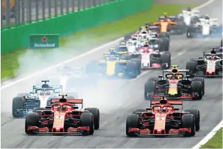  ?? /Dan Istitene/Getty Images ?? No smoke without fire: The Ferraris of Kimi Raikkonen (No 7) and Sebastian Vettel (No 5) lead Lewis Hamilton in his Mercedes, left, into the first corner of the Italian Grand Prix at Monza a fortnight ago.