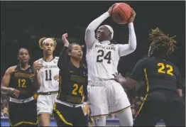  ?? The Associated Press ?? GO FOR IT: Notre Dame’s Arike Ogunbowale (24) goes up for a shot between Bethune-Cookman’s Angel Golden (24) and Tania White (22) during a first-round game in the NCAA women’s college basketball tournament in South Bend, Ind., Saturday.