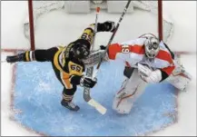  ?? GENE J. PUSKAR — THE ASSOCIATED PRESS ?? There’s no love lost between the Penguins and Flyers, as this crease confab between Pittsburgh forward Jake Guentzel and Flyers goalie Alex Lyon in a March 25 game attests.