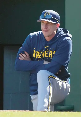  ?? CHARLIE RIEDEL/AP ?? Milwaukee Brewers manager Craig Counsell watches from the dugout during the third inning of a spring training game against the Kansas City Royals on Feb. 27 in Surprise, Ariz.