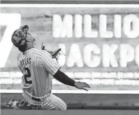  ?? ASSOCIATED PRESS ?? Brewers shortstop Luis Urias makes a running catch on a ball hit by the Nationals’ Nelson Cruz during the first inning Saturday at American Family Field.