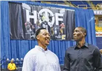  ?? STAFF PHOTO BY DOUG STRICKLAND ?? Former UTC basketball stars Johnny Taylor, right, and Chris Mims talk before Terrell Owens’ Pro Football Hall of Fame induction event Saturday at McKenzie Arena. Owens was known for his football prowess but also played basketball with the Mocs.