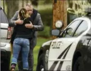  ?? THE ASSOCIATED PRESS ?? Pennsylvan­ia State Police Lieutenant Brian Vennie is embraced by a friend during sentencing for convicted cop killer Eric Frein on Wednesday at the Pike County Courthouse in Milford, Pa. Frein, the would-be revolution­ary who shot two Pennsylvan­ia...