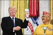  ?? TOM BRENNER/THE NEW YORK TIMES ?? President Donald Trump stands with Thomas Begay, a Navajo code talker, during an event honoring Navajo veterans of World War II. He used a favorite Native American-related insult, deriding Sen. Elizabeth Warren, D-Mass., as “Pocahontas.”