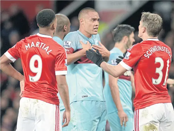  ??  ?? Manchester United’s Bastian Schweinste­iger, right, in an altercatio­n with West Ham’s Winston Reid, centre, on Dec 5.