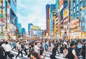  ?? ?? Tokyo cityscape, including the dizzying Tokyo Skytree, main, and crossing the road in Shinjuku.