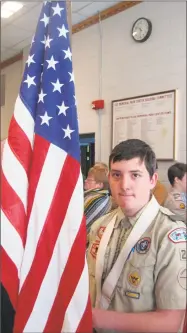  ?? John Torsiello / Hearst Connecticu­t Media ?? Torrington Boy Scout Troop 23 member Anthony DiPippo holds the United States flag.