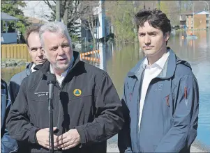  ?? CP PHOTO ?? Canadian Prime Minister Justin Trudeau and Liberal MP Steve MacKinnon (left) listen to Quebec Premier Philippe Couillard speak to the media after touring an area affected by flooding in Gatineau, Que., Thursday.