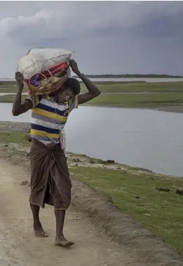  ??  ?? Rohingya refugees, some wearing traditiona­l Myanmar tanaka makeup, continue to arrive in Bangladesh after fleeing violence in Rakhine State Antolin Avezuela for The National