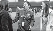  ?? JOHN J. KIM/CHICAGO TRIBUNE ?? New Cubs minor-league coach Rachel Folden, center, talks with colleagues Saturday during a hitting clinic at UIC.