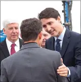  ?? Canadian Press photo ?? Prime Minister Justin Trudeau and Michigan governor Rick Snyder greet Dr. Murray Howe, Gordie Howe's son, in Windsor, Ont., Friday.