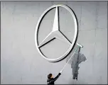  ??  ?? In this file photo, a man works
on a Mercedes logo at the IAA Auto Show in Frankfurt,
Germany. (AP)