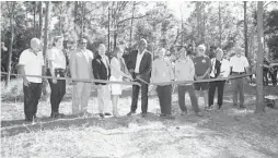 ?? COURTESY OF ORANGE COUNTY GOVERNMENT ?? Orange County Mayor Jerry Demings, center, and Commission­er Maribel Gómez Cordero, left, were on hand for a ribbon-cutting ceremony at Crosby Island Marsh Preserve on Wednesday.