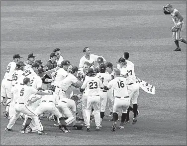  ?? AP/BUTCH DILL ?? (top right) jogs off the field Tuesday as Auburn players celebrate with infielder Edouard Julien after he drove in the winning run, giving the Tigers a 4-3, 11-inning victory over the Wildcats at the SEC Tournament in Hoover, Ala.
