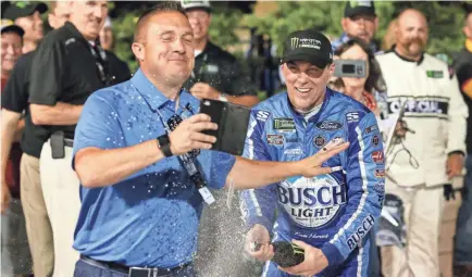  ?? SARAH CRABILL/GETTY IMAGES ?? Kevin Harvick celebrates in victory lane after earning his fifth Monster Energy NASCAR Cup Series victory of the season in Saturday’s KC Masterpiec­e 400 at Kansas Speedway.