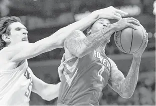  ?? Wally Skalij / Tribune News Service ?? The Rockets’ P.J. Tucker, right, feels the affects of a hard foul by the Clippers’ Boban Marjanovic on Wednesday night in the teams’ renewal of a rivalry that turned contentiou­s during and after the Jan. 15 meeting.