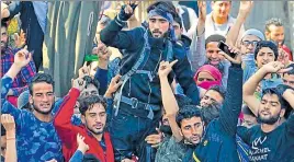  ?? WASEEM ANDRABI /HTFILE ?? A Kashmiri militant is lifted by the crowd as he attends the funeral procession of Hizbul commander Sabzar Ahmed Bhat in the Valley in May.