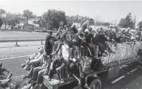  ?? Photo courtesy of Gavin Rogers ?? Gavin Rogers, associate pastor of Travis Park United Methodist Church, joined Hondurans who got a ride on a flatbed trailer.