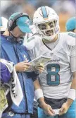  ?? BILL INGRAM / THE PALM BEACH POST ?? Dolphins head coach Adam Gase gives instructio­ns to backup QB Matt Moore before Moore goes in for the injured Ryan Tannehill.