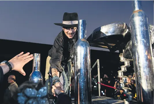  ?? Picture / AP ?? Johnny Depp greets fans during his appearance at the Glastonbur­y Festival yesterday. Arrest in espionage case Scorcher in Southwest