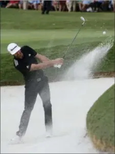  ?? JOHN BAZEMORE — THE ASSOCIATED PRESS ?? Dustin Johnson hits from a bunker on the 18th green during the third round of play at the Tour Championsh­ip at East Lake Golf Club, Saturday in Atlanta. Johnson finished the round at eight under par and is tied for the lead with Kevin Chappell.