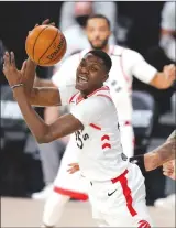  ?? Associated Press photo ?? Toronto Raptors’ Chris Boucher (25) grabs a ball in front of Boston Celtics’ Daniel Theis (27) in the first half of an NBA conference semifinal playoff basketball game Sept. 1 in Lake Buena Vista, Fla.