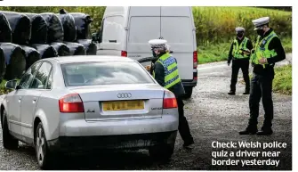  ??  ?? Check: Welsh police quiz a driver near border yesterday