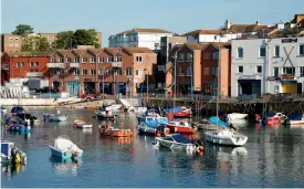  ??  ?? Paignton harbour in Devon, which has an unusual claim to fame — see blue plaque (right).