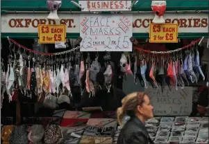  ?? The Associated Press ?? RESTRICTIO­NS: A shop sells face masks on Oxford Street in London, Tuesday. Unemployme­nt across the U.K. rose sharply higher in August which is a clear indication that the jobless rate is set to spike higher when a government salary-support scheme ends this month and new restrictio­ns are imposed on local areas to suppress a resurgence of the coronaviru­s.