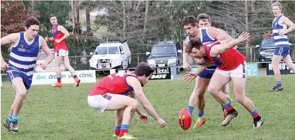  ??  ?? Buln Buln players Luke Nobelius and James Davidson block Neerim-Neerim South’s Chris Urie in his run at the ball.