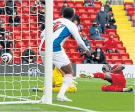  ??  ?? Sadio Mane slides in to score his record-equalling goal against Palace