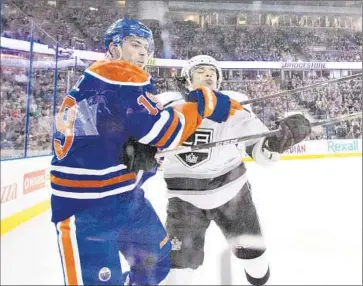  ?? Jason Franson The Canadian Press ?? JORDAN NOLAN, right, of the Kings vies with Edmonton’s Justin Schultz in the first period. The Kings trail the Winnipeg Jets by three points in the race for the final Western Conference wild-card spot.