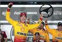  ?? JOHN RAOUX / AP ?? Joey Logano celebrates in Victory Lane after winning the first of two qualifying auto races for the NASCAR Daytona 500 at Daytona Internatio­nal Speedway, on Thursday in Daytona Beach, Fla.