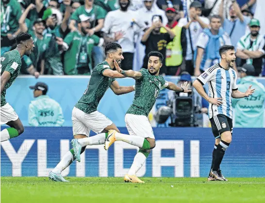  ?? REUTERS ?? Saudi Arabia’s Salem Al-Dawsari celebrates scoring their second goal with teammates against Argentina on Tuesday.