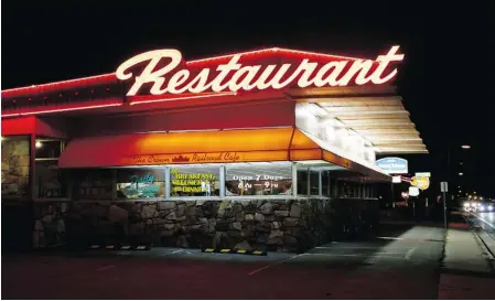  ?? PHOTOS: LYNN FARRELL/ THE GAZETTE ?? Motel and restaurant neon light the way for traffic and travellers along historic Route 66 in Flagstaff, Ariz.