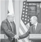  ?? CHRIS MCGRATH/GETTY IMAGES ?? Trump and Putin shake hands in Helsinki.