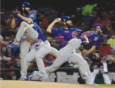  ?? Associated Press ?? ■ In this multiple-exposure picture, Chicago Cubs starting pitcher Jake Arrieta throws against the Cleveland Indians on Wednesday during the fifth inning of Game 2 of the Major League Baseball World Series in Cleveland.