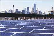  ?? Mark Lennihan / Associated Press ?? A rooftop is covered with solar panels at the Brooklyn Navy Yard in New York. A U.S. trade panel has ruled that low-cost solar panels imported from China and other countries have caused serious injury to American manufactur­ers.